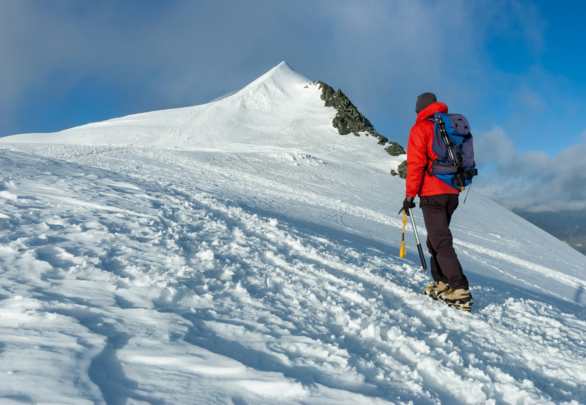 mountaineer-climbs-a-snowy-peak-in-swiss-alps-zermatt-switzerland-.jpg
